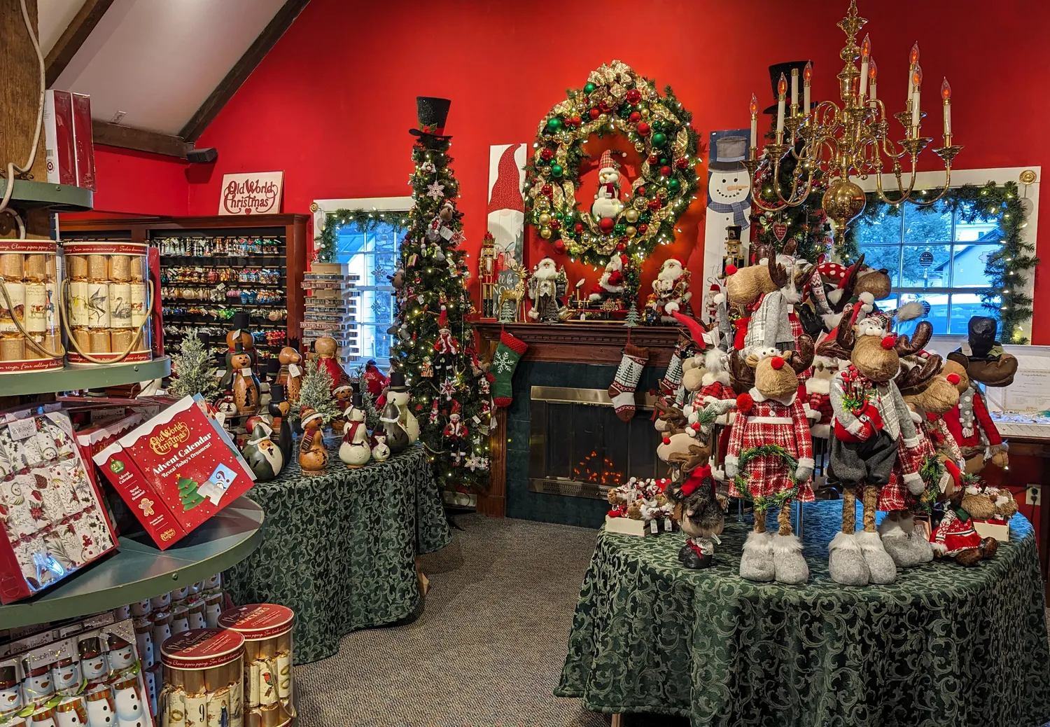 A festive holiday display at Pine Wreath Candle in Peddler's Village. Several tables and shelves adorned with Christmas decor.