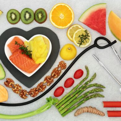 A selection of heart healthy foods on a table with a stethoscope.