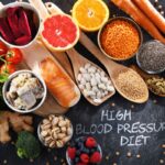A selection of foods on a table that lower blood pressure with a sign that says 'high blood pressure diet"