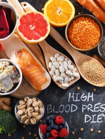 A selection of foods on a table that lower blood pressure with a sign that says 'high blood pressure diet"