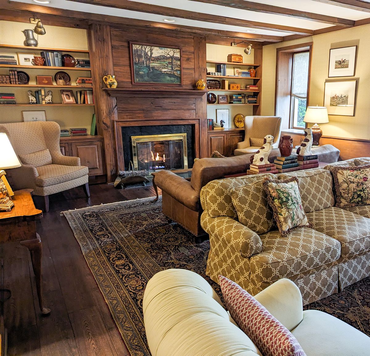 The lobby at Golden Plough Inn with 2 couches, 4 chairs, and a fireplace.