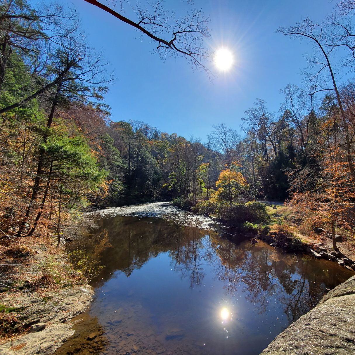 The sun over the water at Wissahickon Valley Park in autumn 