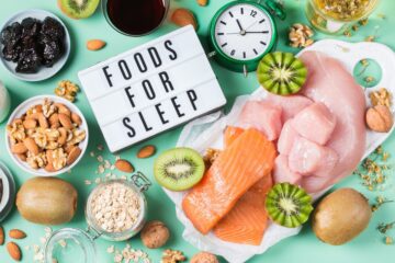 A selection of foods on a table that contain melatonin and a sign reading 'foods for sleep'