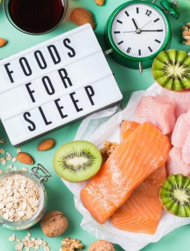 A selection of foods on a table that contain melatonin and a sign reading 'foods for sleep'