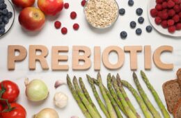 A selection of prebiotic foods on a table with the word PREBIOTIC in wood letters.