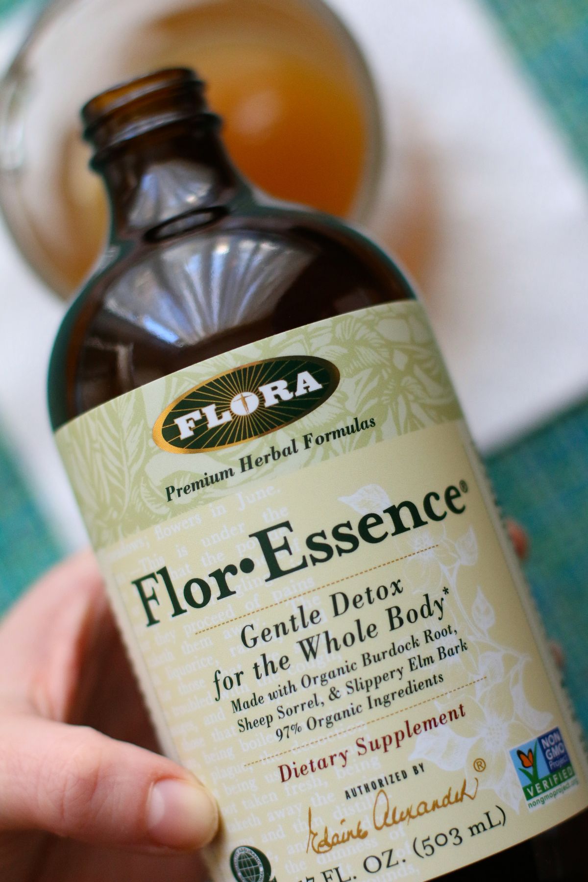 Pouring a bottle of Flor-Essence into a mug.