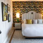 the suite at river house. an open door leading into a king bed with pillows and inviting warm atmosphere