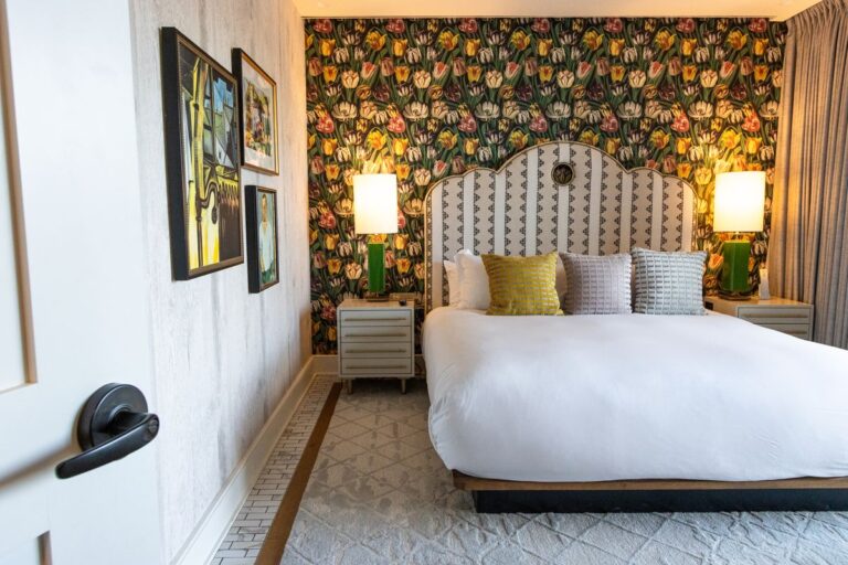 the suite at river house. an open door leading into a king bed with pillows and inviting warm atmosphere