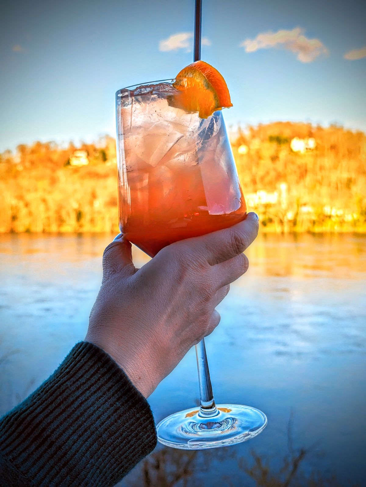 Odette’s Sangria at the Roof lounge atop River House. The Delaware River and mountains at sunset also shown.