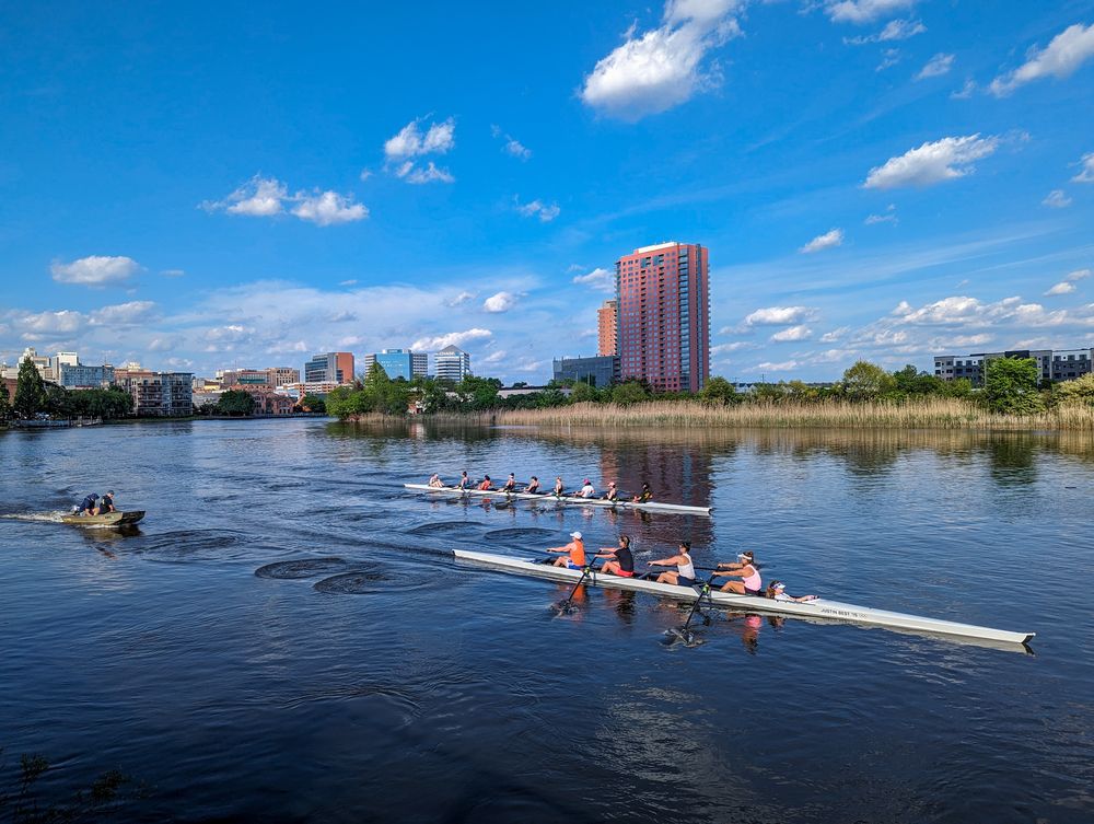 Rowing along the Christina River in Downtown Wilmington, DE. 3 boats and a view of the city. 