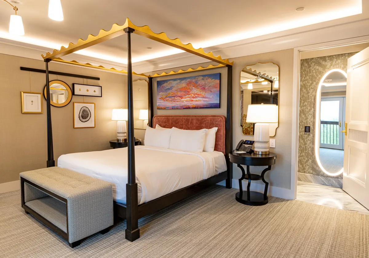 The Bedroom of The Grand King Suite at Nemacolin. A four poster king bed .