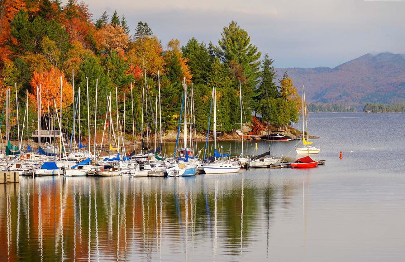 Lake Placid, United States
Tranquil autumn scene of a marina with colorful fall foliage and reflections on the calm lake
