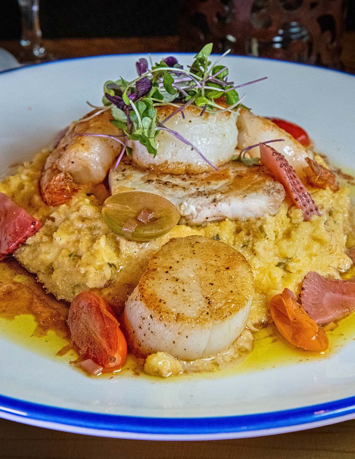 Mixed Seafood a la Plancha with scallops, shrimp, swordfish served over creamy chive and mascarpone polenta at Earl's New American.