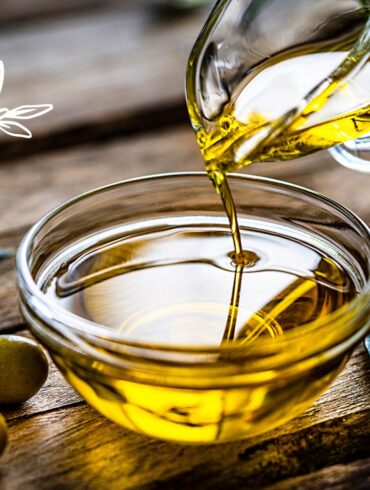 Olive oil pouring into a small clear bowl