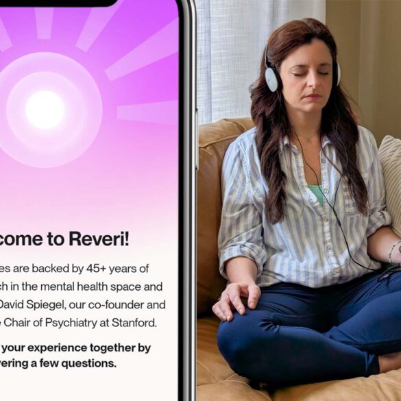 Split image showing a smartphone on the left displaying Reveri's welcome screen with a purple radial sunburst pattern and white center circle. The screen reads "Welcome to Reveri!" followed by text explaining "Our exercises are backed by 45+ years of clinical research in the mental health space and created by Dr. David Spiegel, our co-founder and the Associate Chair of Psychiatry at Stanford." Below states "Let's shape your experience together by answering a few questions." On the right side, a woman sits cross-legged on a tan leather couch wearing a light blue striped shirt and dark jeans. She has brown hair, closed eyes in a meditative state, and wears white headphones connected to a smartphone displaying a pink/orange gradient interface. Her hands rest naturally on her legs, and the setting shows a peaceful living room with natural lighting through sheer curtains and a textured throw pillow visible on the couch.
