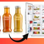 3 BBQ sauce Bottles next to an open refrigerator with an arrow