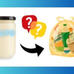 a mayonnaise mayo jar with a black arrow and 2 question marks point to a garbage bag