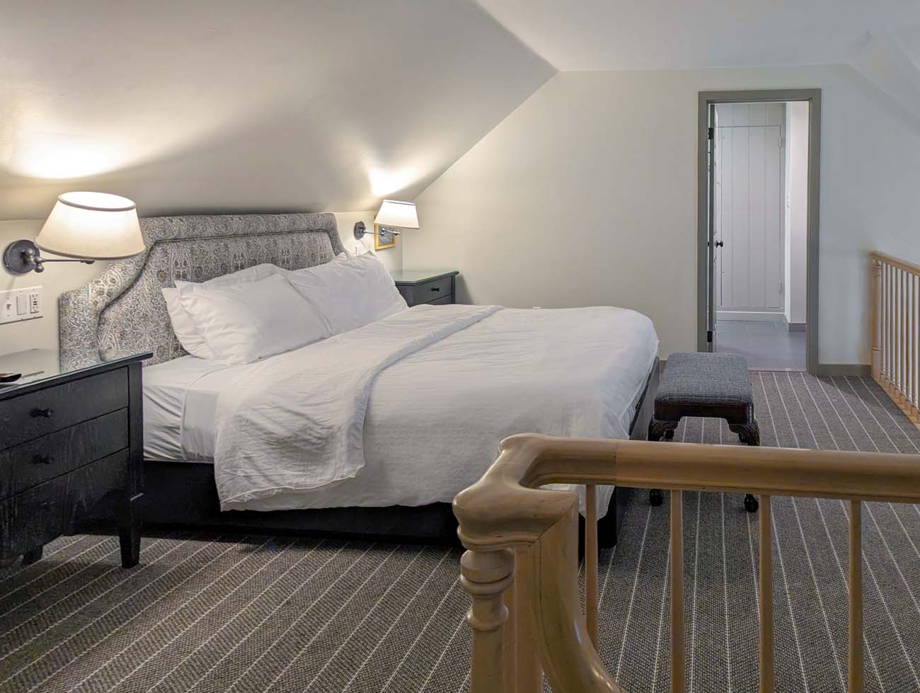Upper level king bedroom in Golden Plough Inn bi-level suite at Peddler's Village.