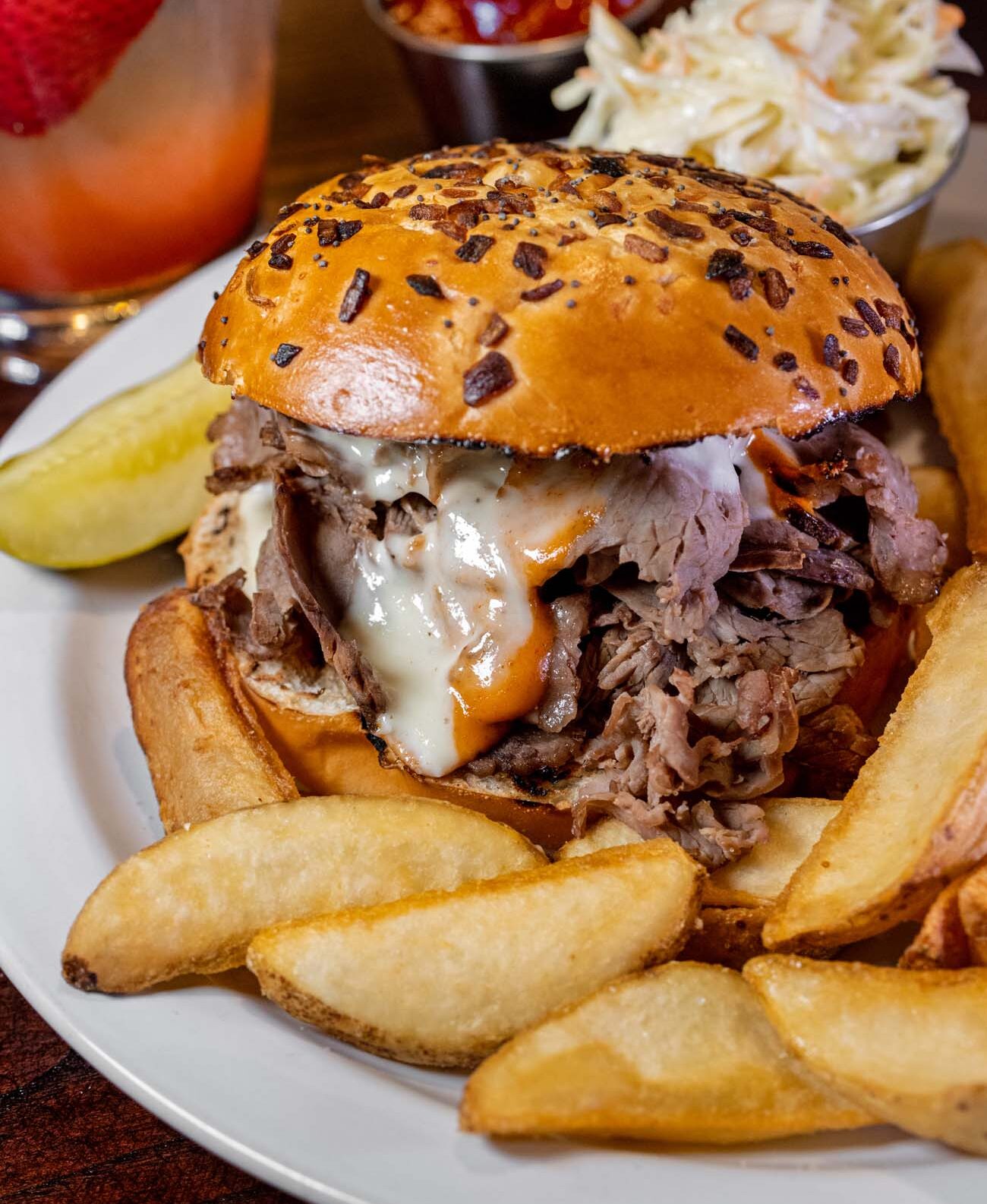 Prime Rib Melt with fries slaw and a cocktail
