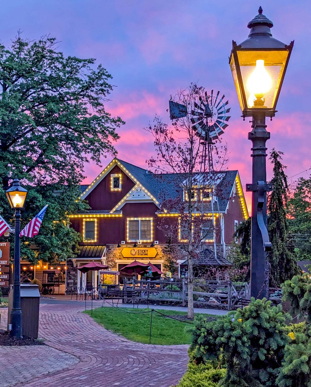 A magical summer night at Peddler's Village with illuminated gazebo and lit pathways.