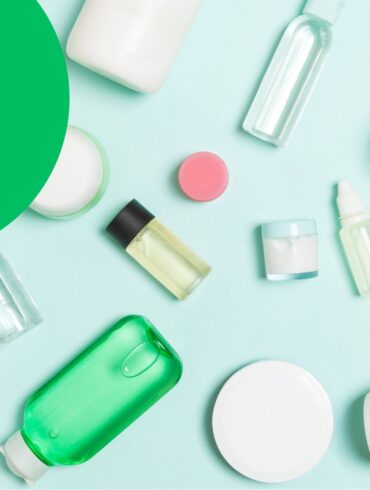 Overhead of different travel size bottles on a light blue surface with a question mark