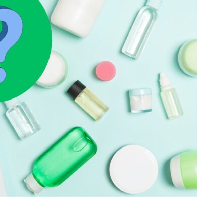 Overhead of different travel size bottles on a light blue surface with a question mark