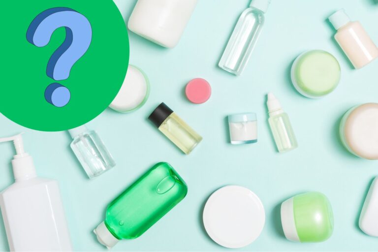 Overhead of different travel size bottles on a light blue surface with a question mark