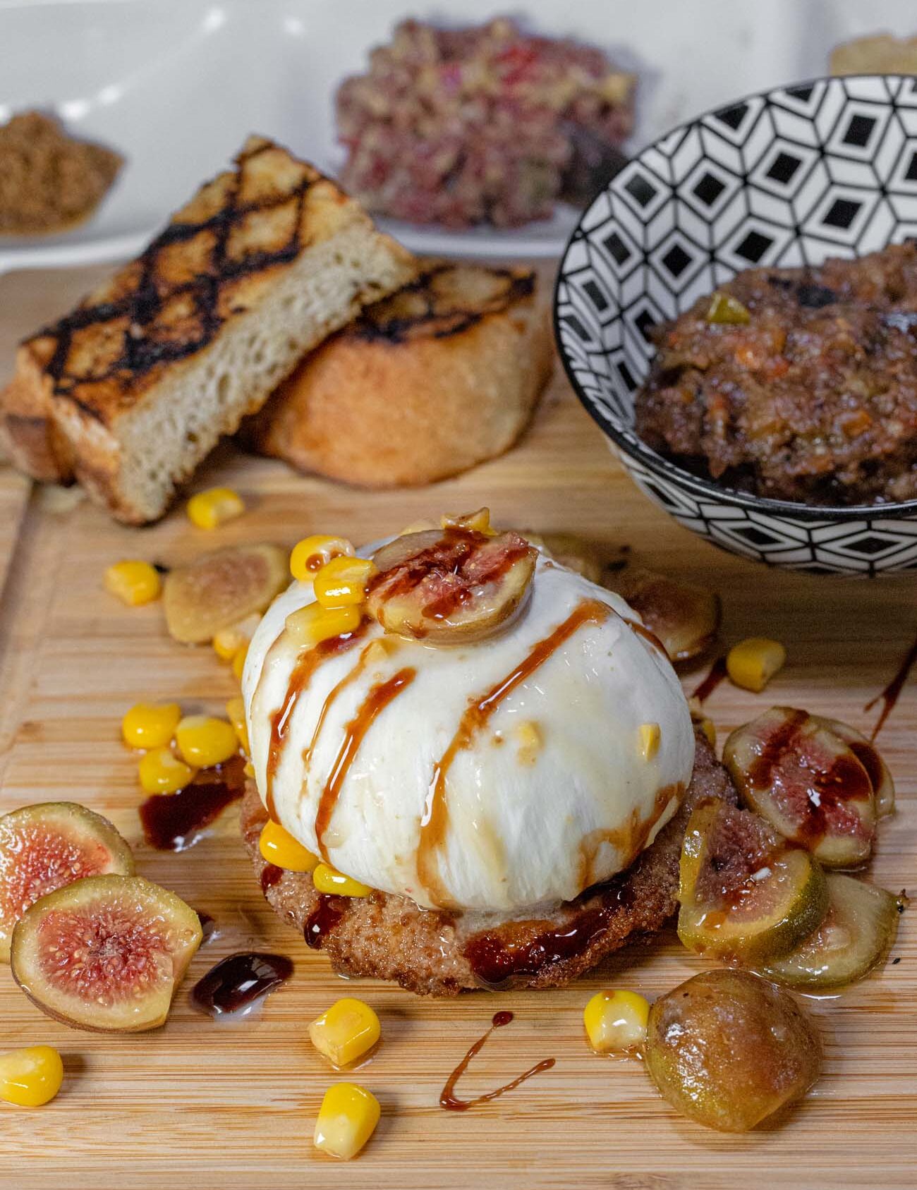 Brampton 1860 Review: A Timeless Retreat on the Eastern Shore 30 An elegant appetizer plate at The Kitchen at the Imperial featuring burrata cheese over fried green tomatoes with grilled figs, balsamic reduction, and microgreens.