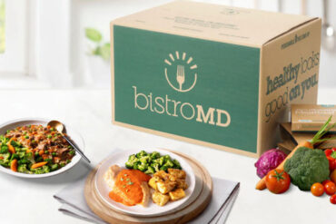 bistroMD meal deliver box with prepared plates and healthy, fresh veggies on a kitchen counter