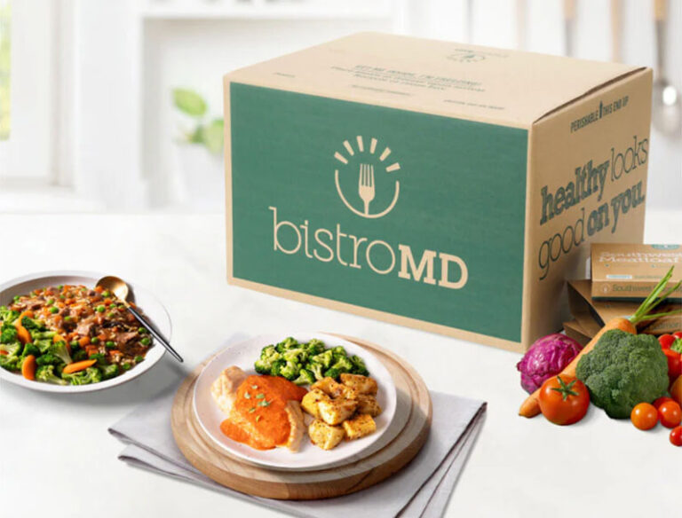 bistroMD meal deliver box with prepared plates and healthy, fresh veggies on a kitchen counter
