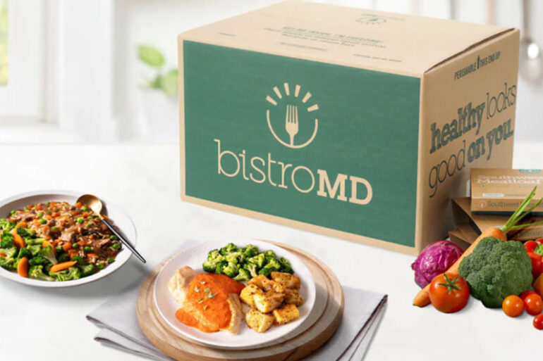 bistroMD meal deliver box with prepared plates and healthy, fresh veggies on a kitchen counter