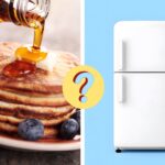 maple syrup poured on pancakes next to a refrigerator