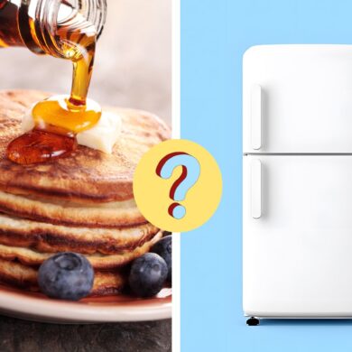 maple syrup poured on pancakes next to a refrigerator