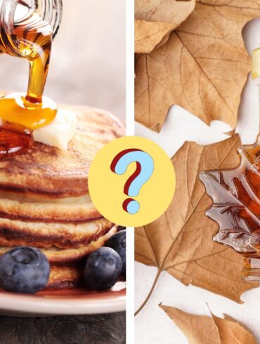 maple syrup poured on pancakes next to a leaf shaped jar of maple syrup