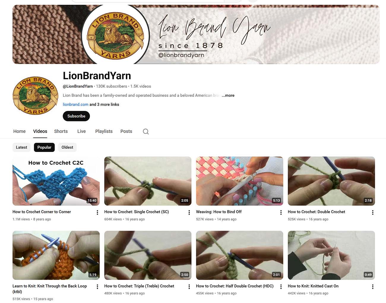 Screenshot of Lion Brand Yarn YouTube channel homepage showing tutorial videos for crochet and knitting techniques, with channel banner, subscribe button, and video thumbnails for corner-to-corner crochet, single crochet, and various stitch tutorials