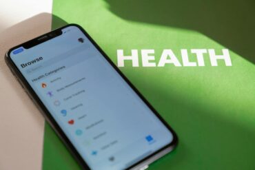 a mobile phone with health and wellness apps installed on a green folder that says health