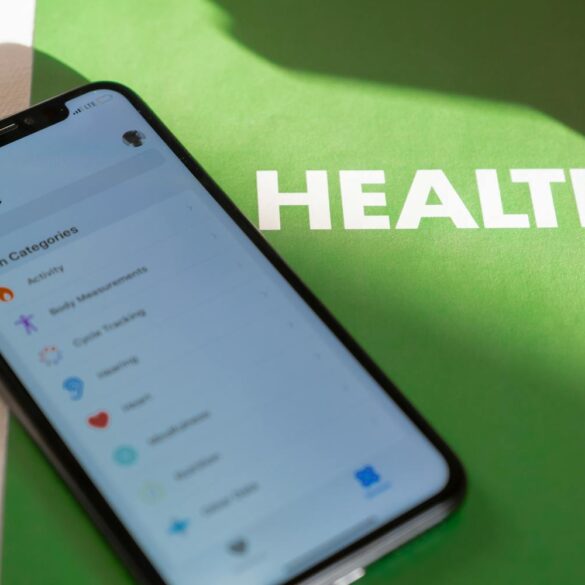 a mobile phone with health and wellness apps installed on a green folder that says health