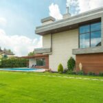 A Beautiful House with Swimming Pool Near the Garden with Green Grass