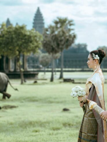 A couple in Cambodia enjoying the scenery with a building and elephant
