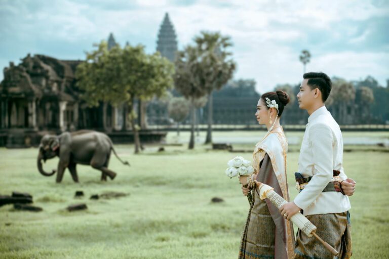 A couple in Cambodia enjoying the scenery with a building and elephant