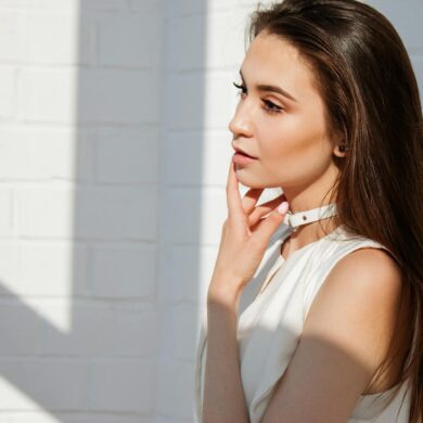 A young woman with glowing skin and natural makeup photographed in soft natural light, representing the subtle and refreshed look that defines high fidelity beauty standards in 2026 aesthetic medicine