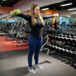 a woman at the gym working out her shoulders