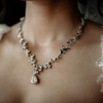 a woman wearing an elegant diamond necklace