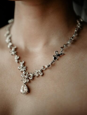 a woman wearing an elegant diamond necklace
