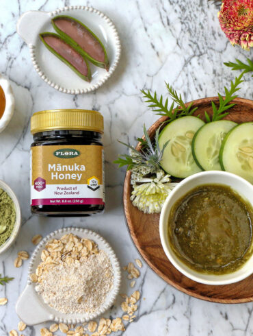 a flat lay of a jar of manuka honey surrounded around all the different types of things and ingredients that you can do with it