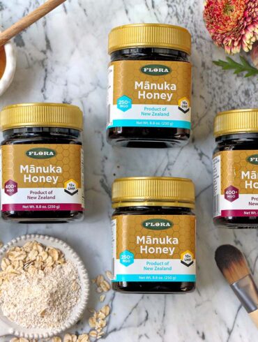a selection of 4 manuka honey containers with different ratings