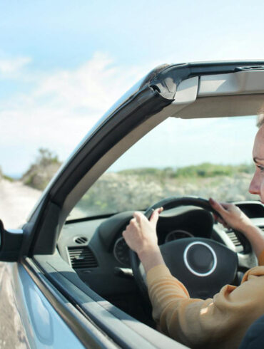 Woman in Brown Jacket Driving Car