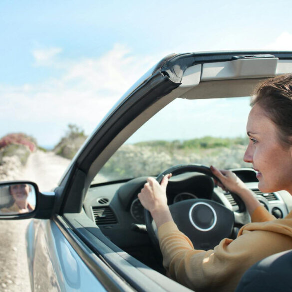 Woman in Brown Jacket Driving Car