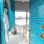 Elegant modern bathroom with vibrant Sukabumi shower tiles and skyline view, embodying luxury and style.
