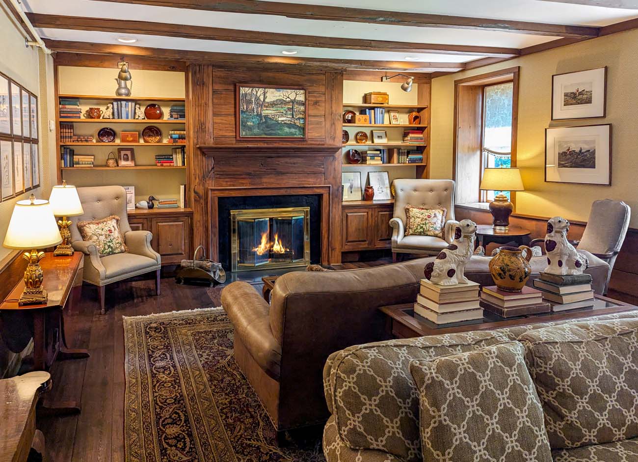 The cozy lobby at Golden Plough Inn with couches, chairs, and a fireplace.